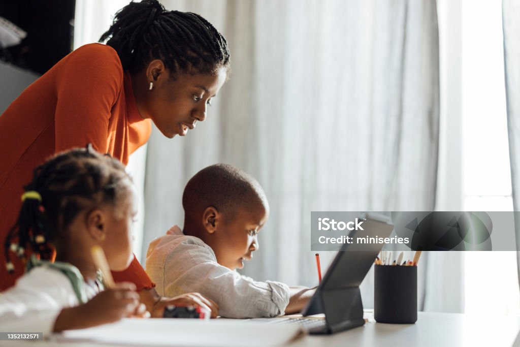 A mother homeschooling her children